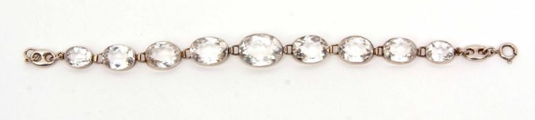 White metal "Pool of Light" crystal bracelet, a design of 9 graduated oval faceted crystals, each in