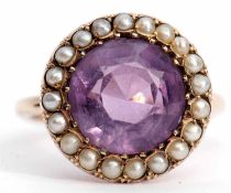 Amethyst and seed pearl ring, the circular cut faceted amethyst (10mm diam) set within a surround of