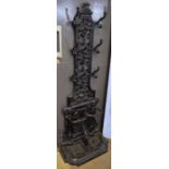 Black painted cast metal hall stand, central panel with hooks, foliate scrolls etc, lower section