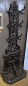 Black painted cast metal hall stand, central panel with hooks, foliate scrolls etc, lower section