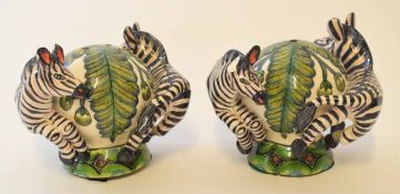 Cruet set modelled as two antelope surrounding a globular vase, the base signed "Painted in