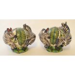 Cruet set modelled as two antelope surrounding a globular vase, the base signed "Painted in