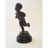 20th century patinated brass model of a running child on a stepped circular socle, height 13cm