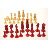 Early 20th century European bone/ivory chess set of natural and red stained form, height of King 9cm