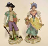 Pair of Continental porcelain figurines on scroll bases, modelled as a gardener and flower seller,