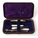 Cased part manicure set, the hinged and gilt highlighted morocco covered case with silk and velvet