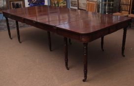 Regency period mahogany extending dining table with moulded frieze and raised on ten ring turned