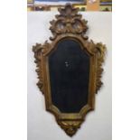 Decorative gilt framed wall mirror, framed moulded with scrolls and masks below, 74cm high