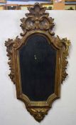 Decorative gilt framed wall mirror, framed moulded with scrolls and masks below, 74cm high