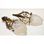 Two various brass and copper electric light fittings with embossed foliate and scroll work detail in