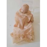 20th century porcelain headed sleeping baby doll in peach coloured christening robes with lace