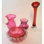 Group of cranberry coloured glass, one with a label for Swedish Art Glass, comprising vase, ewer and