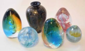 Group of five paperweights and a glass vase modelled in various colours, one paperweight stamped "