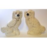Pair of large Staffordshire poodles, black noses, yellow eyes, with gilt effect chains