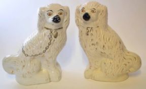 Pair of large Staffordshire poodles, black noses, yellow eyes, with gilt effect chains