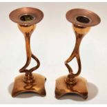 Pair of Art Nouveau style cast copper candlesticks each with detachable nozzles to integral shaped