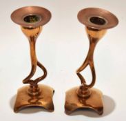 Pair of Art Nouveau style cast copper candlesticks each with detachable nozzles to integral shaped