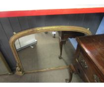 Victorian gilded overmantel mirror of arched form, applied on either side with scroll mounts,