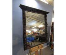 19th century Gothic oak overmantel mirror, the uprights moulded with lion mask, foliage and fruit