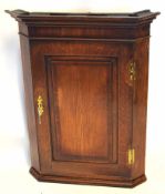 Early 19th century oak corner cupboard panelled door enclosing fitted shaped shelving, 82cm wide