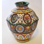 Italian or Spanish pottery globular vase with indented panels of landscapes in majolica type glazes,