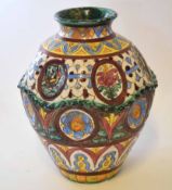 Italian or Spanish pottery globular vase with indented panels of landscapes in majolica type glazes,