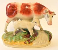 Staffordshire model of a cow with calf