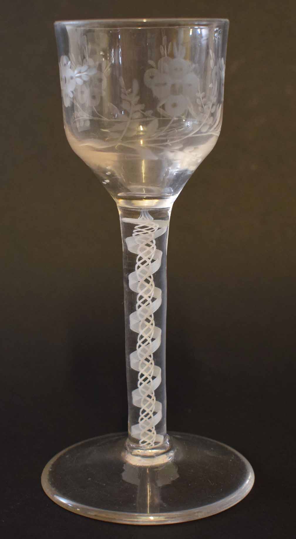 Mid-18th century wine glass with air twist stem and the bowl with an engraved design, 14cm high