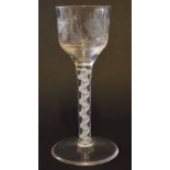 Mid-18th century wine glass with air twist stem and the bowl with an engraved design, 14cm high