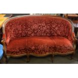 Mahogany sofa with arched back over a break front frieze and raised on moulded cabriole supports,