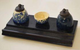 Porcelain mounted and ebonised ink stand comprising two porcelain reservoirs with blue and white