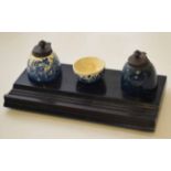 Porcelain mounted and ebonised ink stand comprising two porcelain reservoirs with blue and white