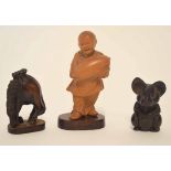 Carved Oriental figure of a boy together with two further wooden carvings, model of a gazelle and