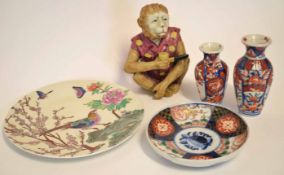 Chinese model of a monkey smoking a pipe, together with a Japanese porcelain Imari dish and