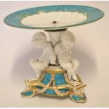 Mid-19th century Royal Worcester tazza modelled as three cherubs with linked arms on a turquoise