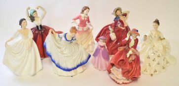 Group of eight Royal Doulton figurines including "Top of the Hill" and "Autumn Breezes", largest