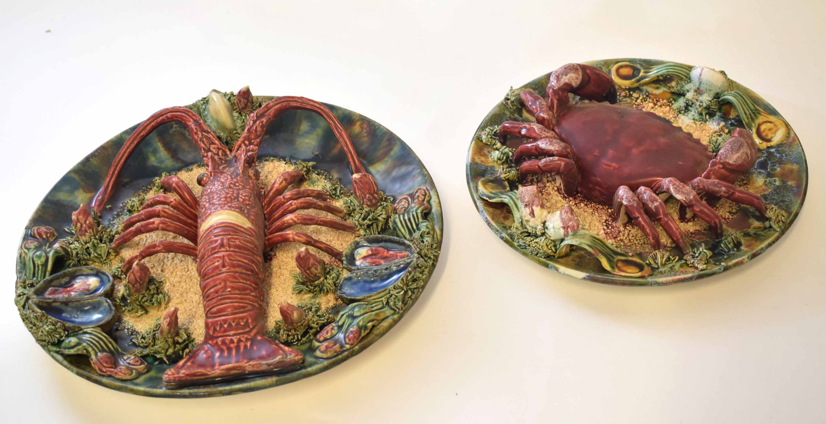 Two dishes with Pallasey type glazes, one with a crab, the other with a lobster, surrounded by