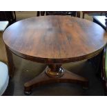 Early 19th century rosewood circular pedestal dining table, tri-form base with compressed bun