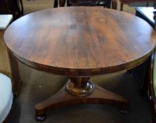 Early 19th century rosewood circular pedestal dining table, tri-form base with compressed bun