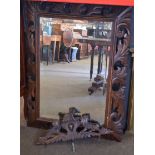 Carved oak wall mirror of rectangular form with foliate frame, crest decorated with lions etc, 75