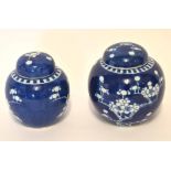 Pair of Chinese porcelain ginger jars and covers decorated with prunus on a blue ground, 12cm high