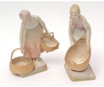 Pair of Austrian Turn pottery figures modelled as girls carrying baskets on a stepped base, the