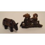Pair of Oriental carvings, one of a rhinoceros and the other a horse