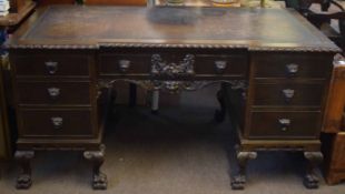 Early 20th century mahogany twin pedestal desk, applied throughout with lion mask mounts and on claw