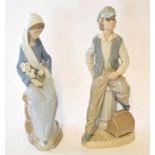 Two Lladro or Nao Spanish porcelain figures, one of a young boy, the other of a young girl, the