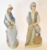 Two Lladro or Nao Spanish porcelain figures, one of a young boy, the other of a young girl, the