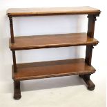 19th century mahogany three-tier buffet with planked ends with scrolling supports raised on four bun
