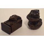 Two wooden netsuke modelled as frogs, one in sitting position, one on a square box
