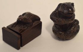 Two wooden netsuke modelled as frogs, one in sitting position, one on a square box