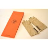 Pair of late 20th century ladies kidskin gloves, Hermes, of stitched beige form and each fitted with